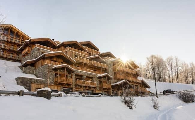 Ski-in, ski-out chalet exterior with private balconies and stone facade
