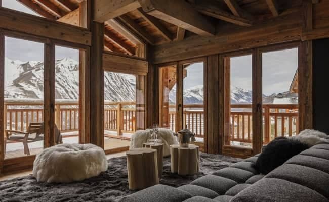Living area with floor-to-ceiling windows and panoramic mountain views