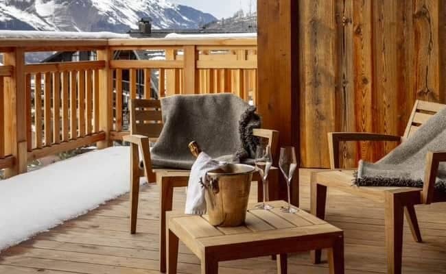 Private balcony with mountain views and wood-slat seating