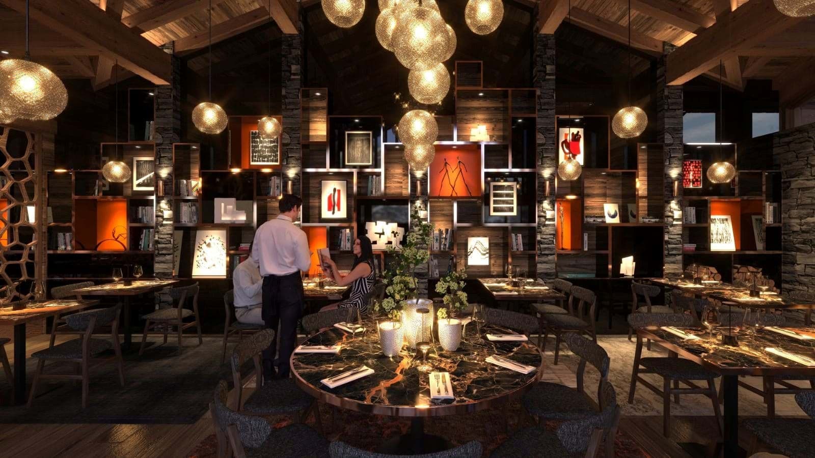 On-site restaurant with round marble tables and curated library wall