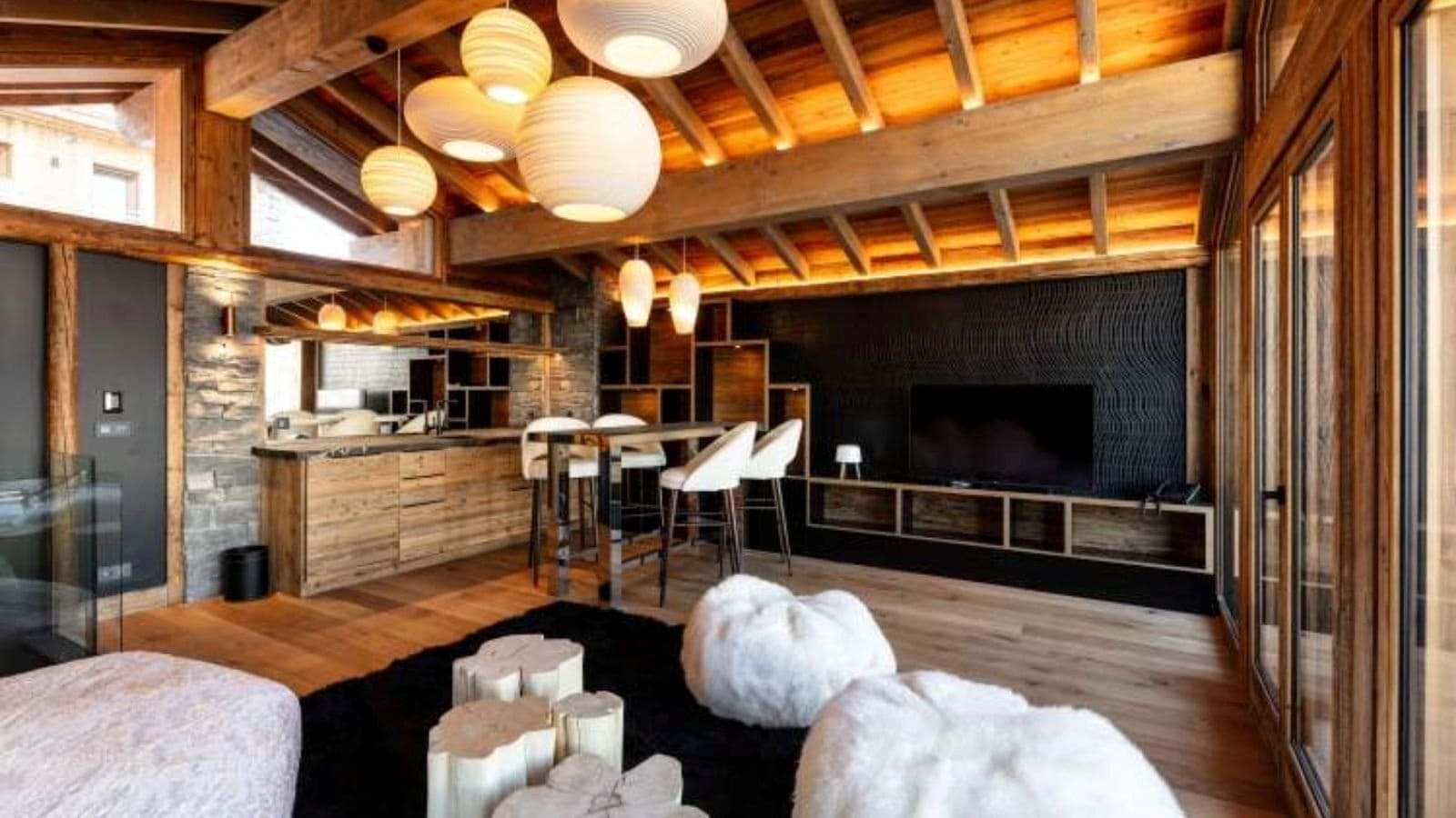 Open living area with vaulted timber ceilings and breakfast bar seating