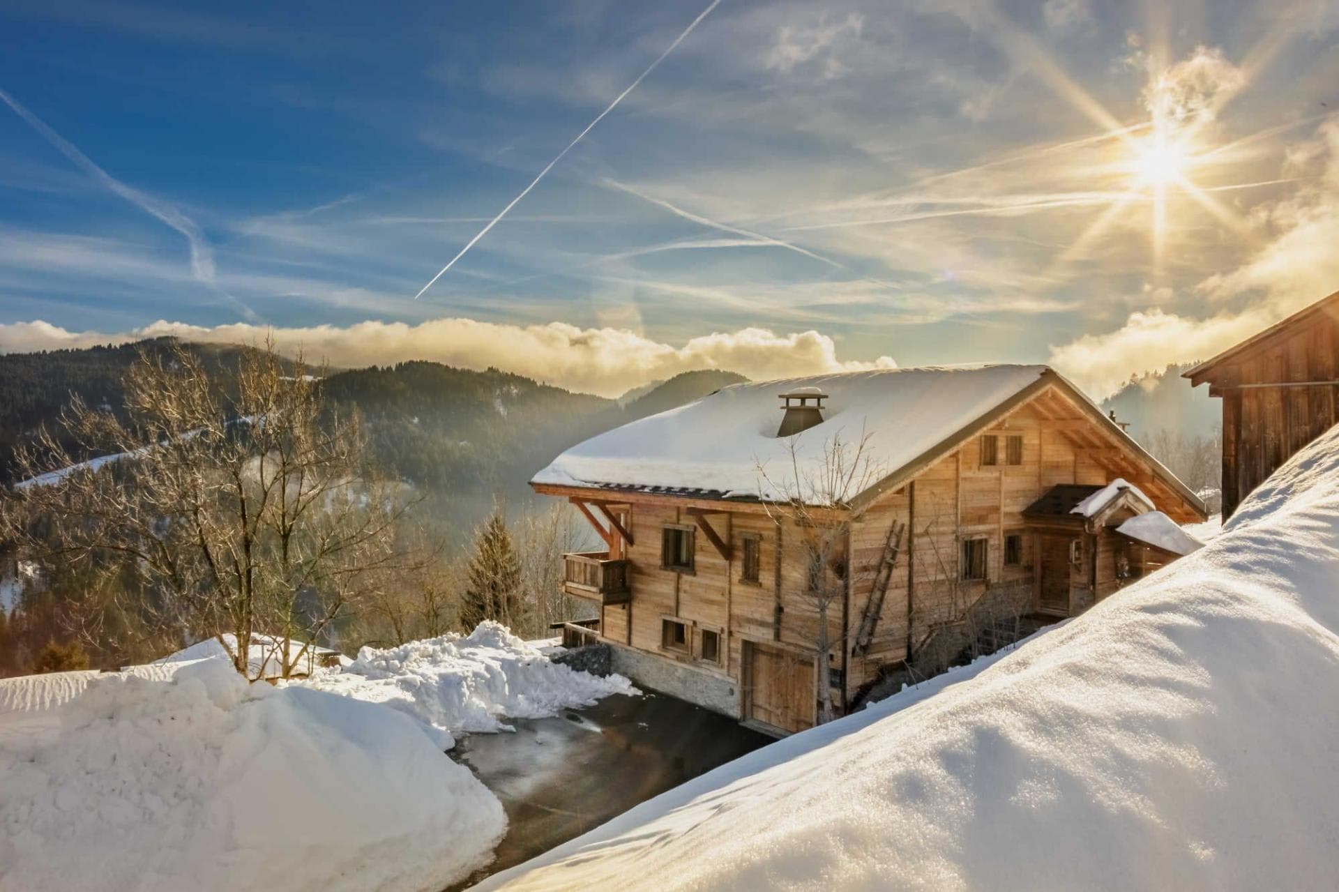 Ski-in chalet exterior with private parking and valley mountain views