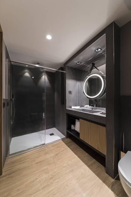 Bathroom with walk-in shower and lighted vanity mirror