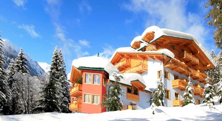 Ski-in chalet exterior featuring private timber balconies and mountain views