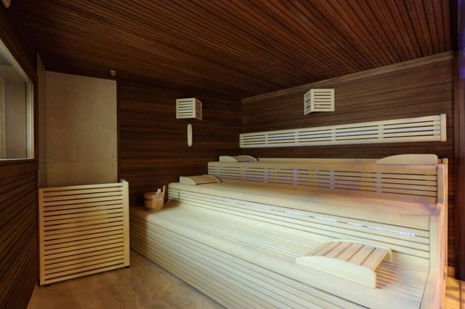 Private cedar sauna with multi-level seating and integrated LED lighting