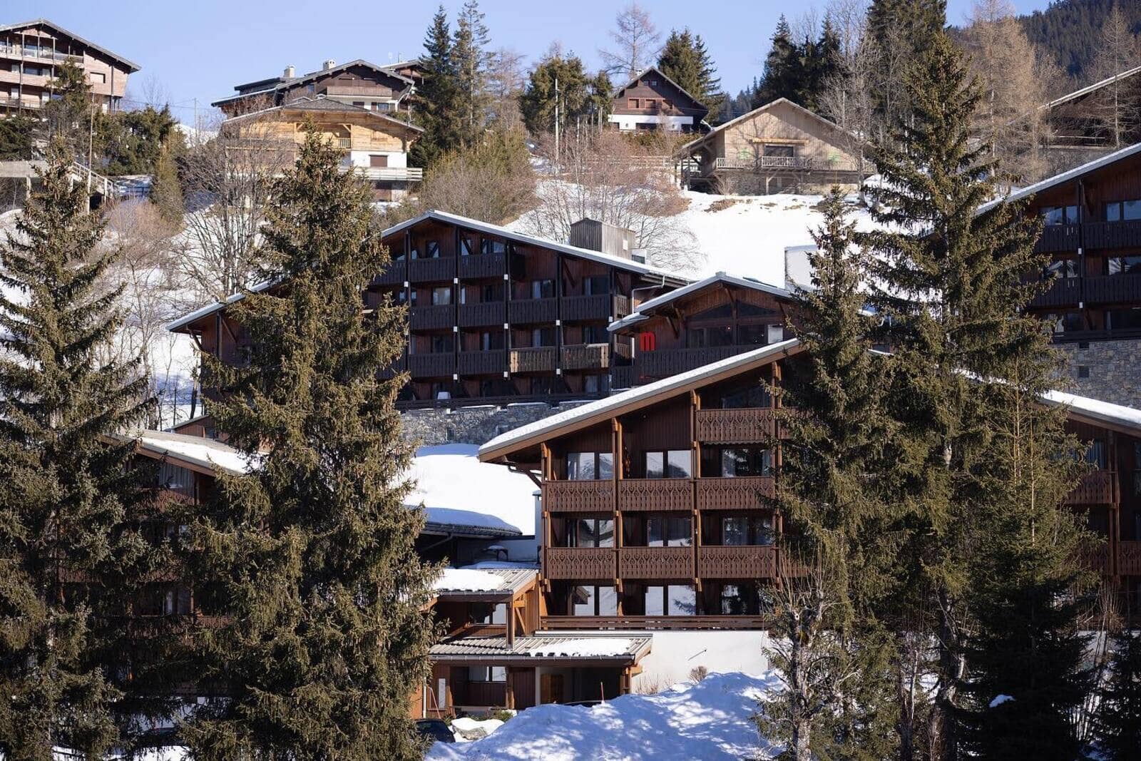 Alpine timber chalets with private balconies and hillside views