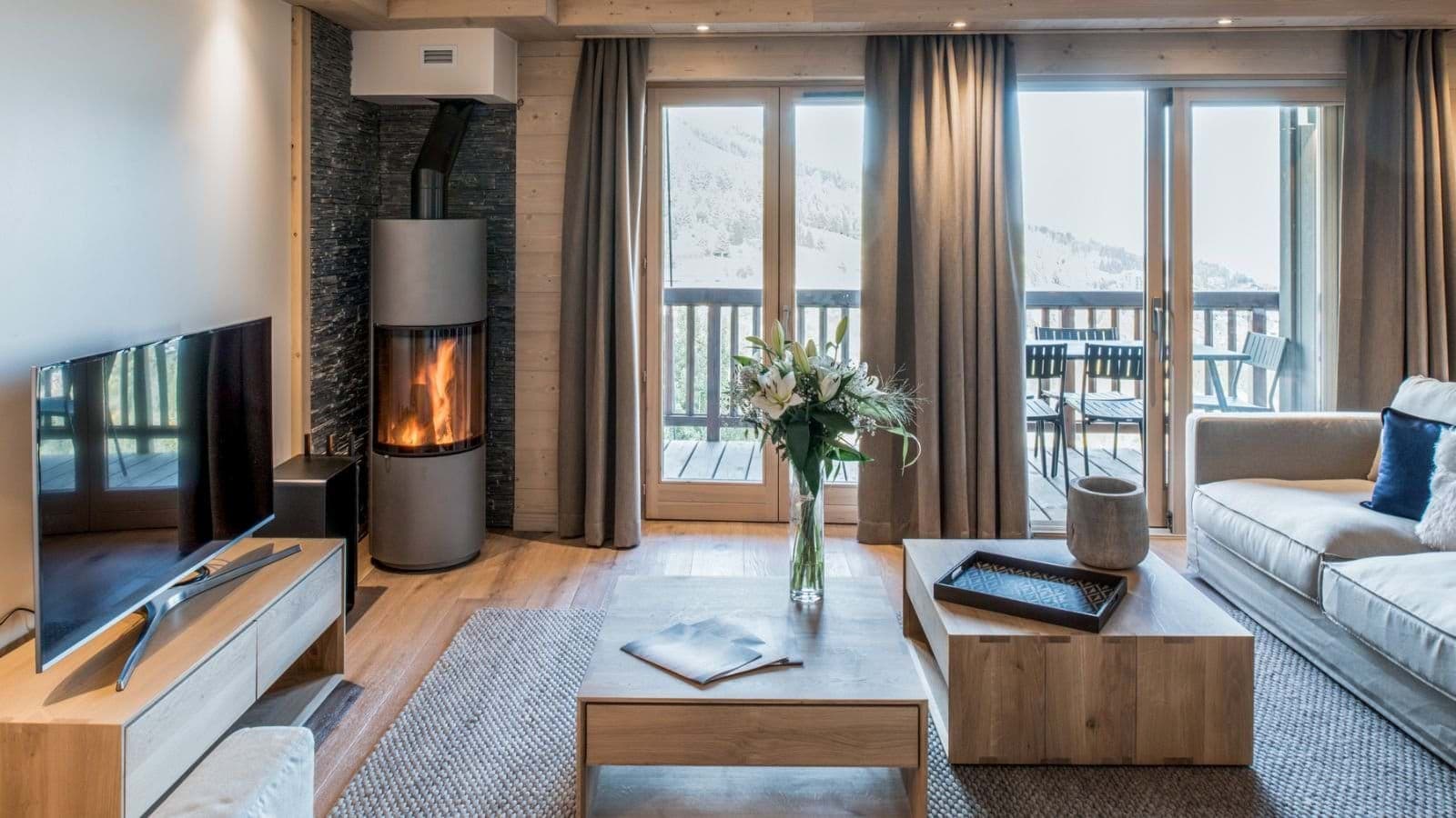 Living area with wood-burning stove and private balcony access