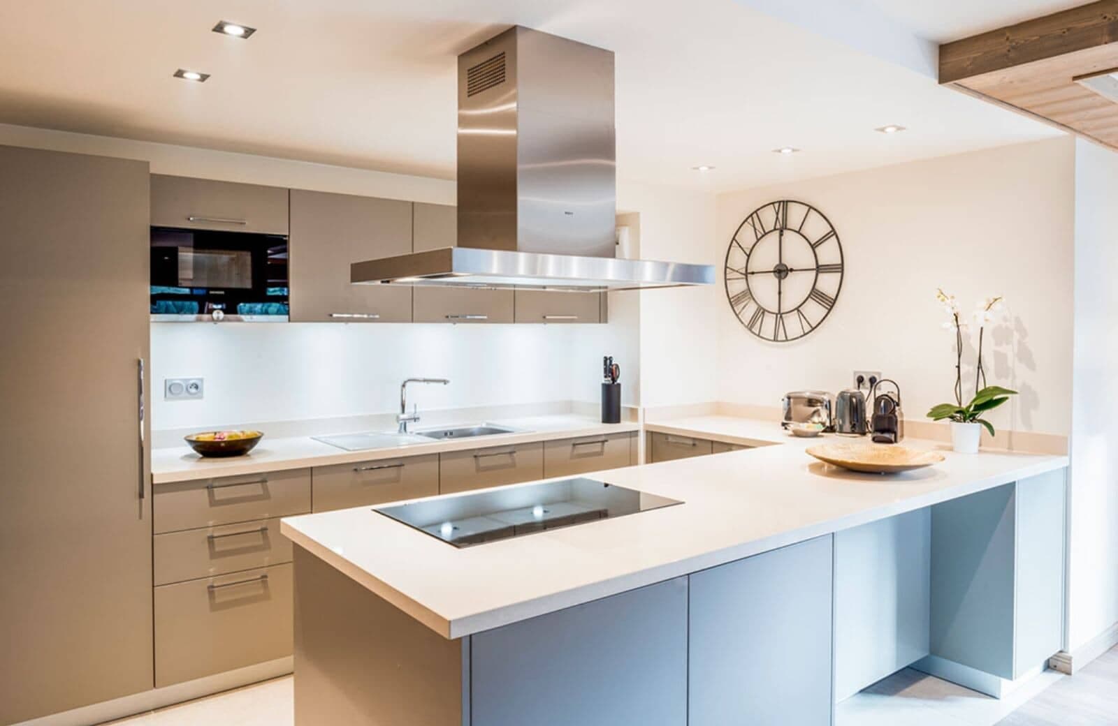 Kitchen with island induction cooktop and integrated appliances