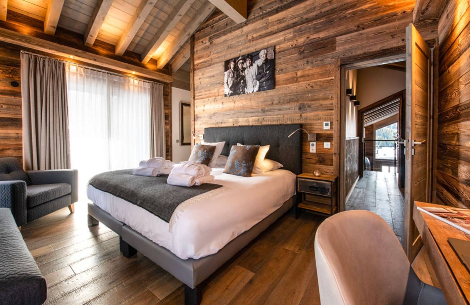 Bedroom with king bed and desk; vaulted wood ceilings
