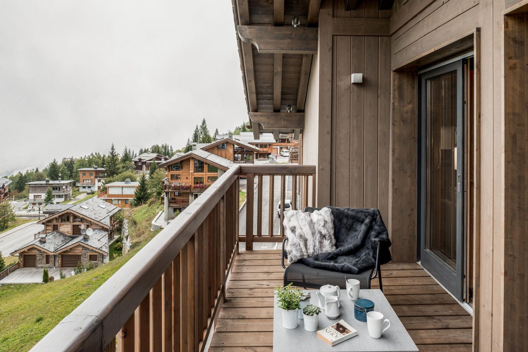 Wooden balcony with village views and outdoor seating