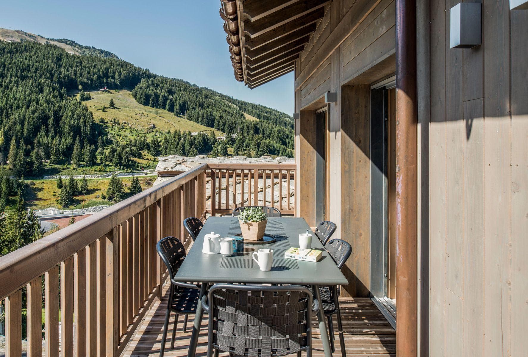 Balcony dining table seats 6 with views of alpine forest