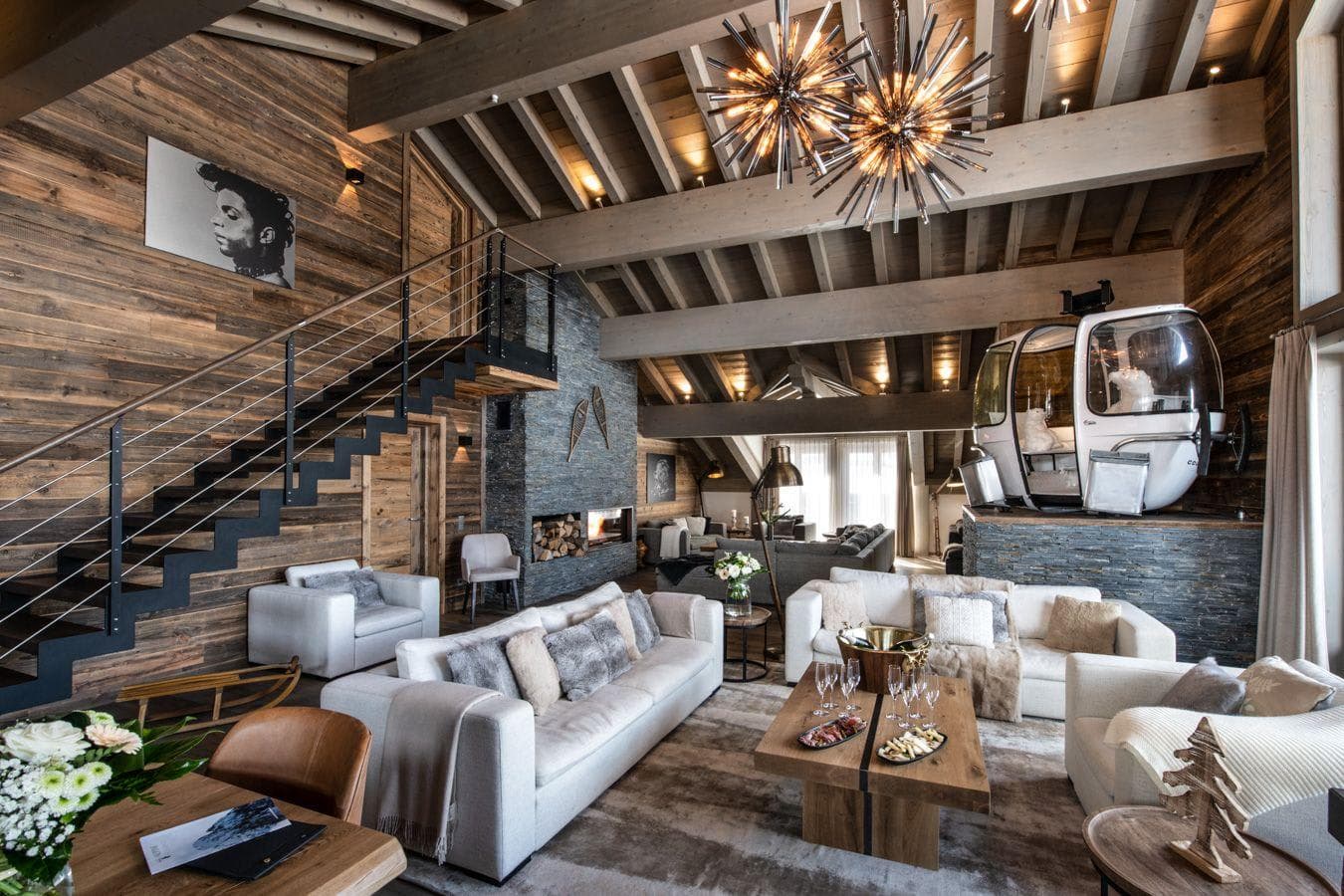 Living room with wood-beamed ceilings and integrated gondola car seating