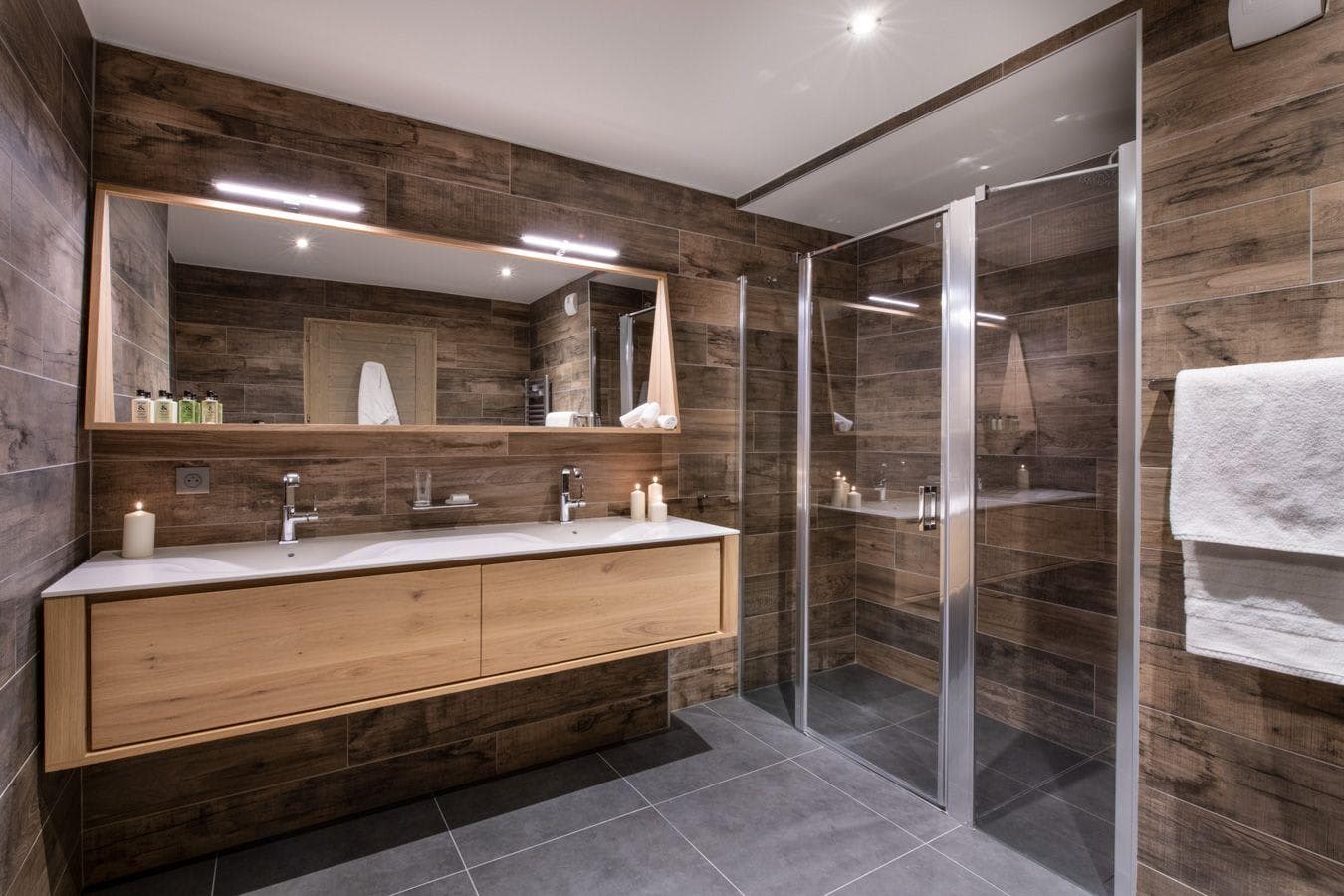 Bathroom with dual vanity and walk-in glass shower