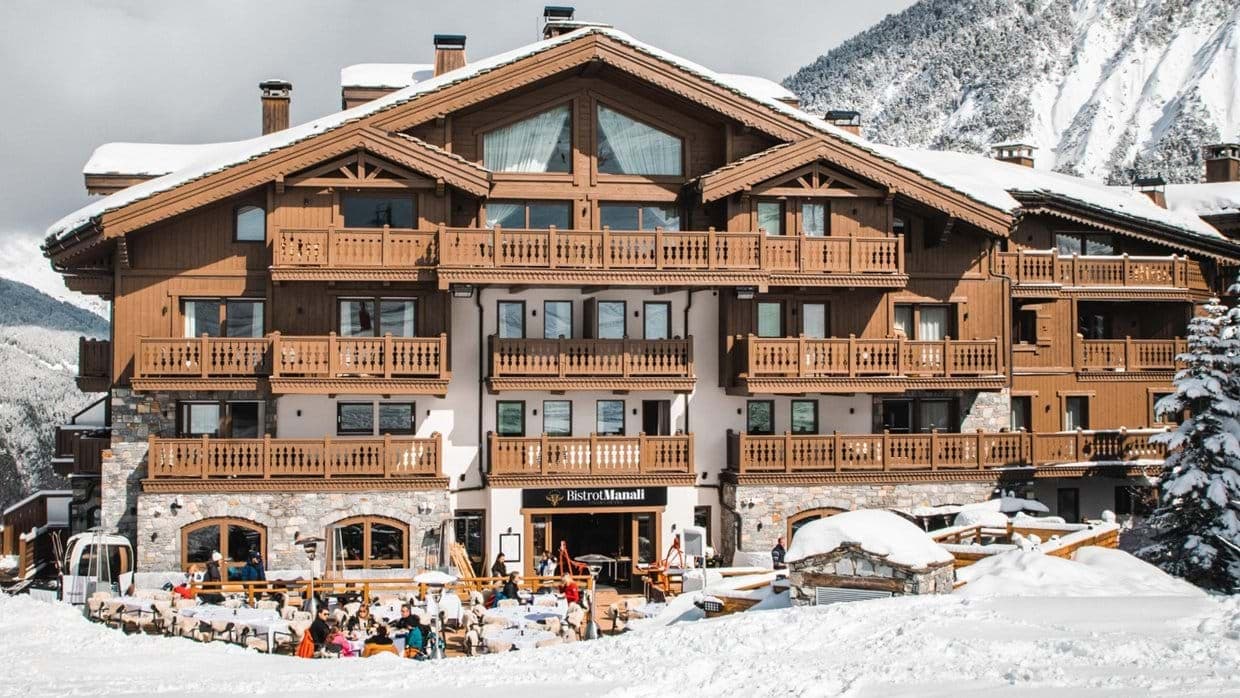 Ski-in, ski-out chalet exterior with mountain views and terrace restaurant