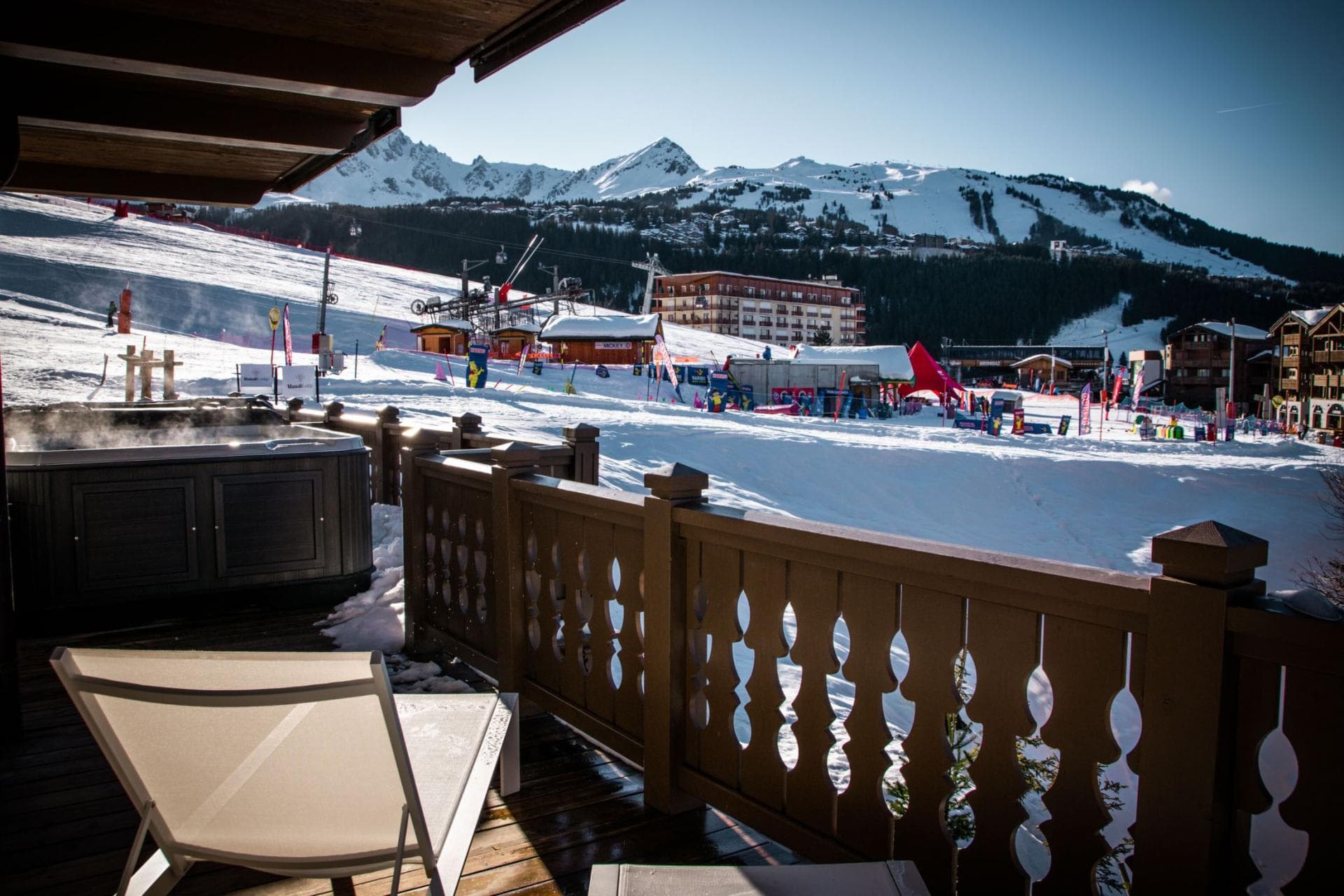 Deck with ski slope and mountain views; overlooks active resort base