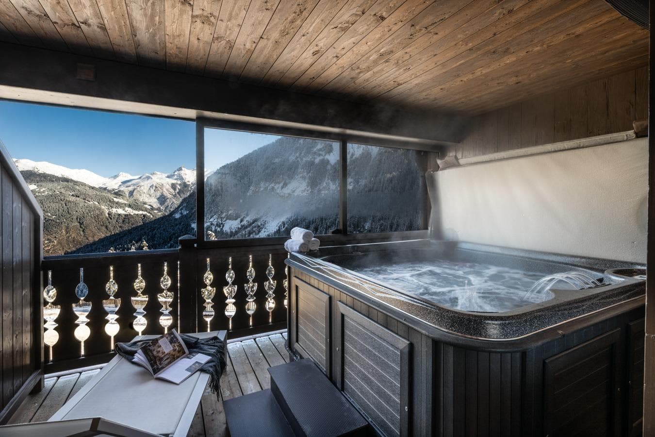 Covered balcony hot tub with panoramic mountain and valley views
