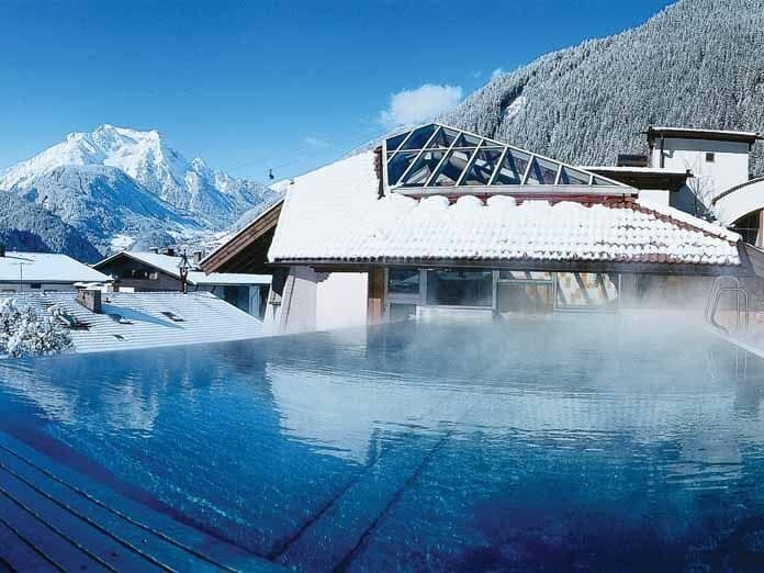Heated outdoor pool with infinity edge and mountain views