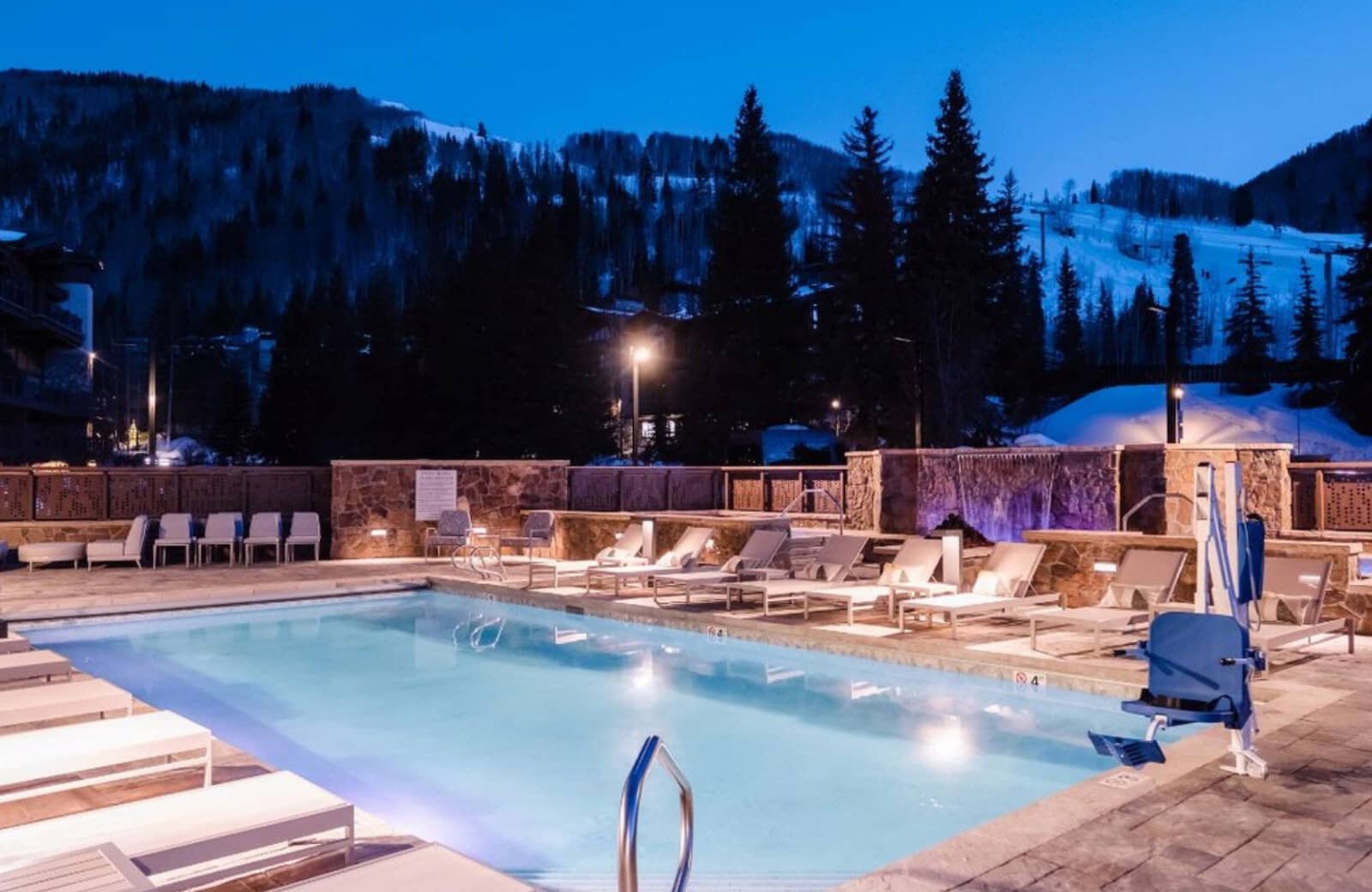 Heated outdoor pool and lounge area with mountain views and ADA lift