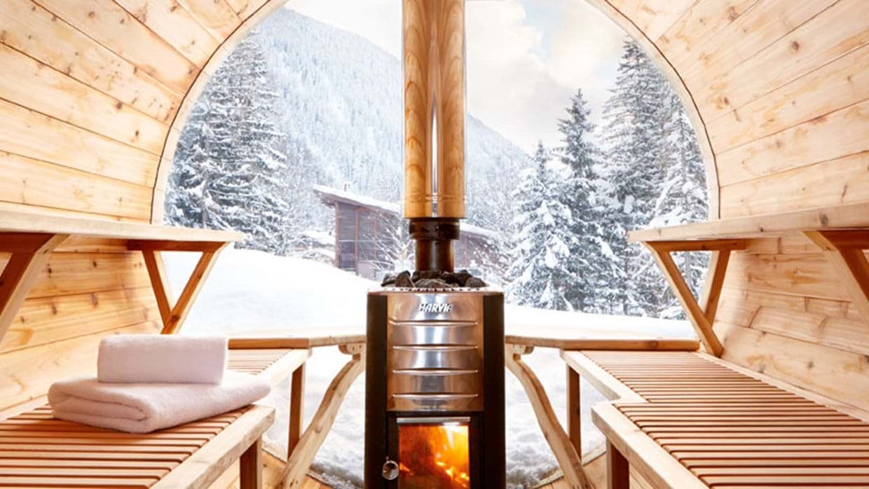 Wood-fired barrel sauna with Harvia heater and panoramic mountain views