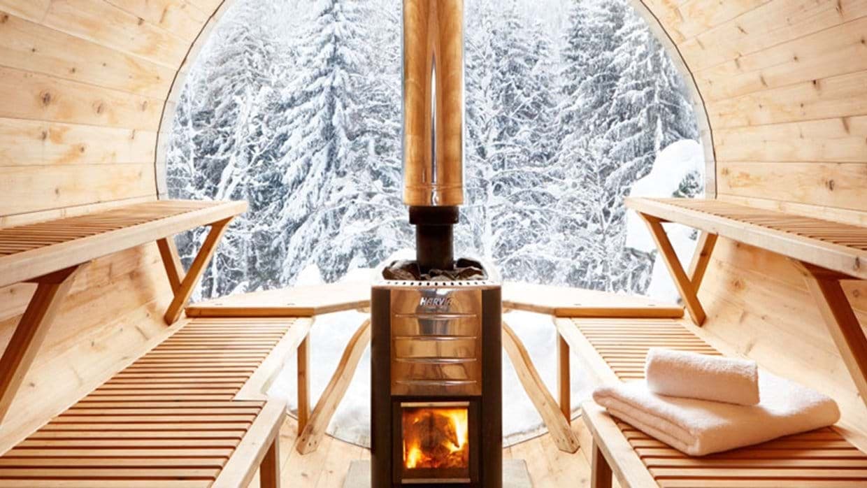 Wood-burning barrel sauna with Harvia stove and panoramic forest view