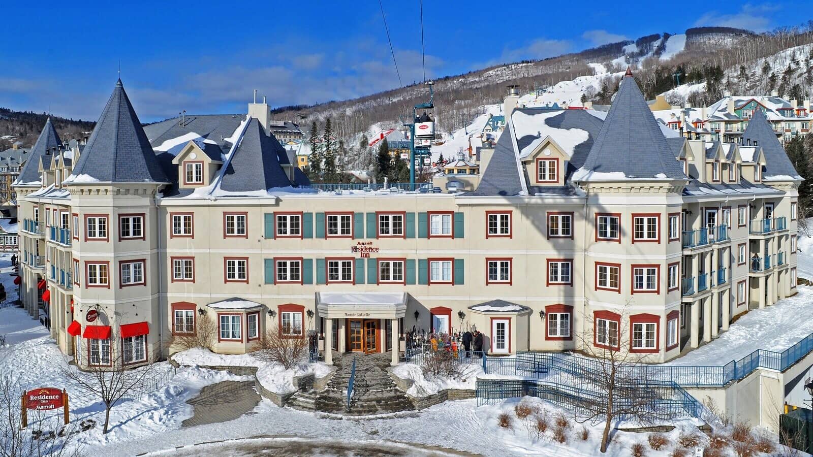 Ski-in/ski-out lodge exterior with direct access to gondola and mountain trails