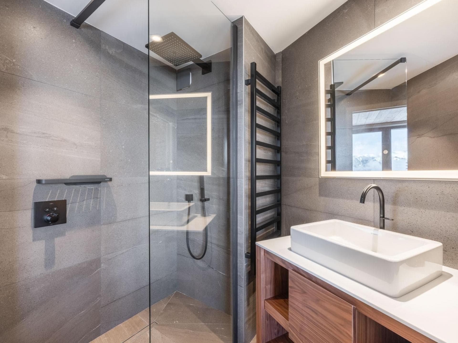 Bathroom with walk-in rainfall shower and heated towel rack