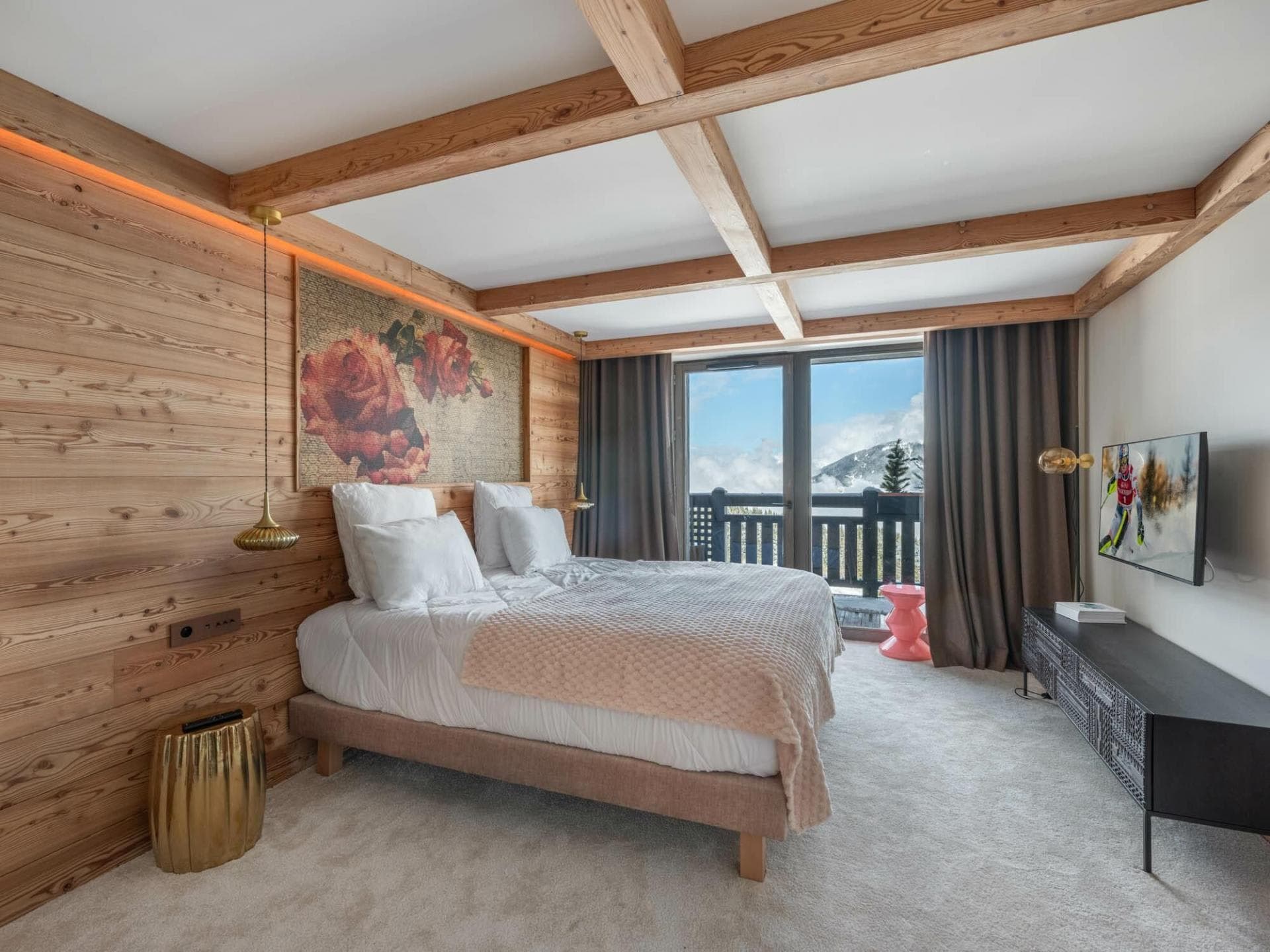 Primary bedroom with king bed and private balcony access to mountain views