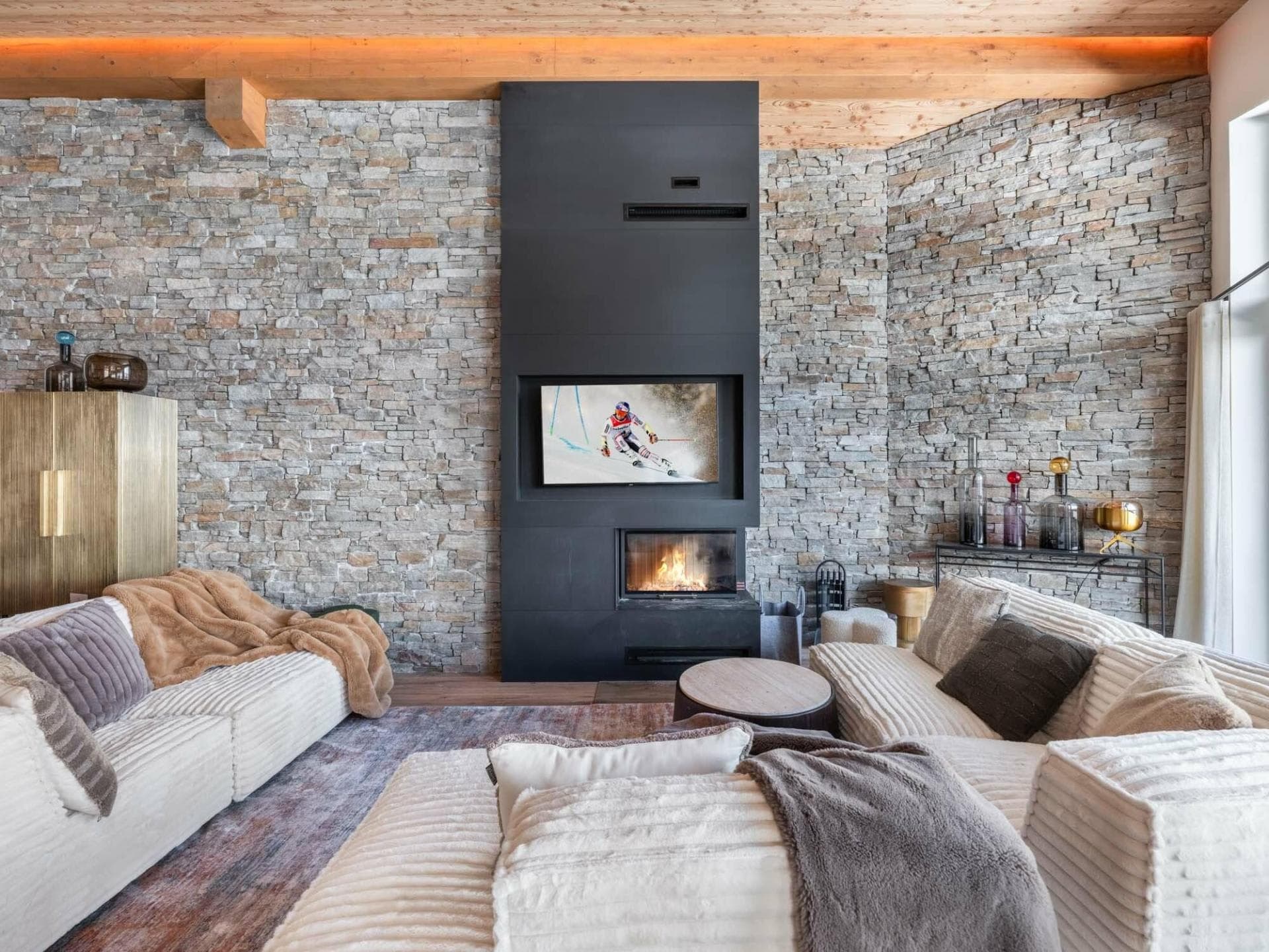 Living area with wood-burning fireplace and recessed smart TV