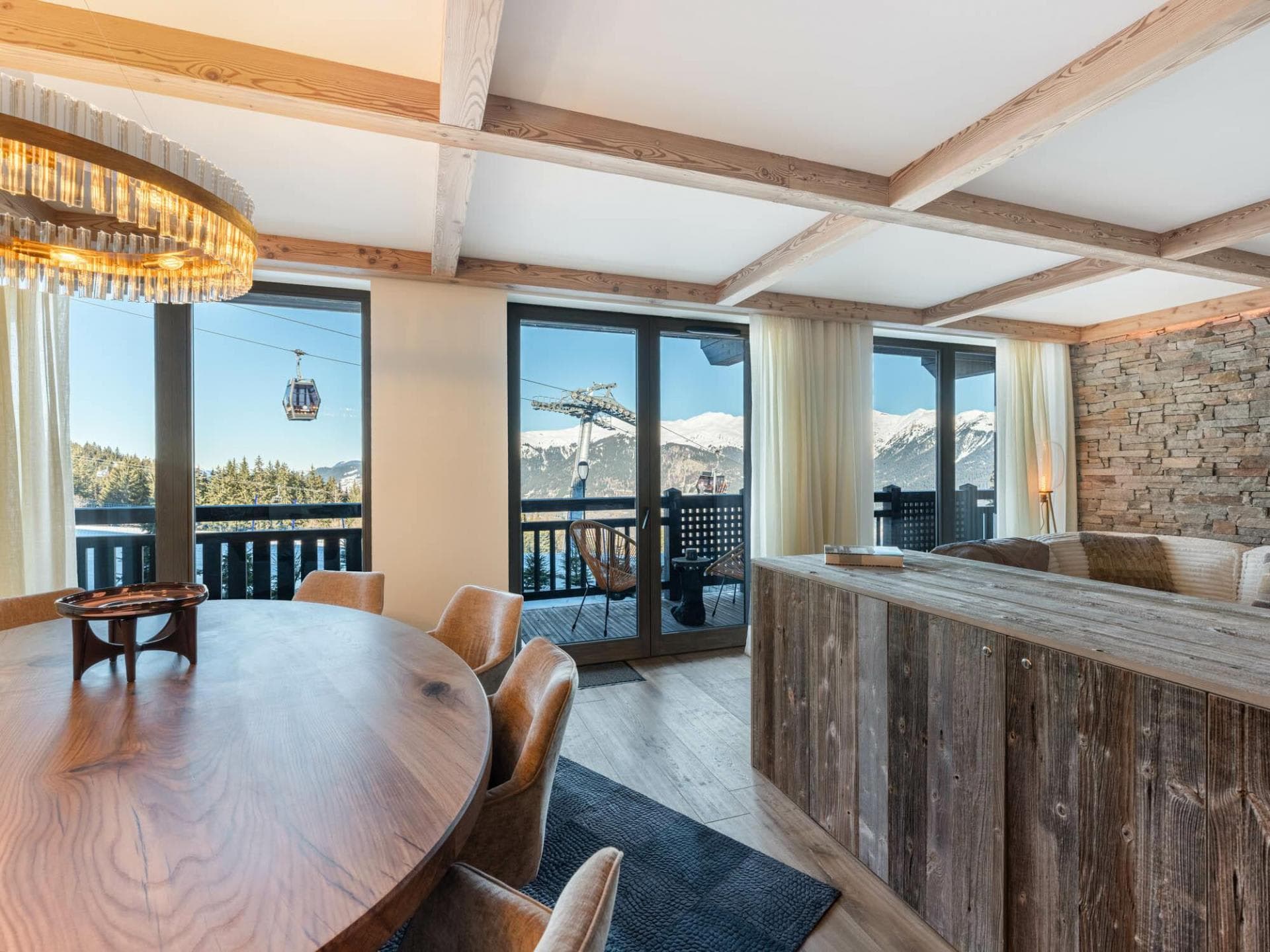 Dining area and balcony access with views of the ski gondola