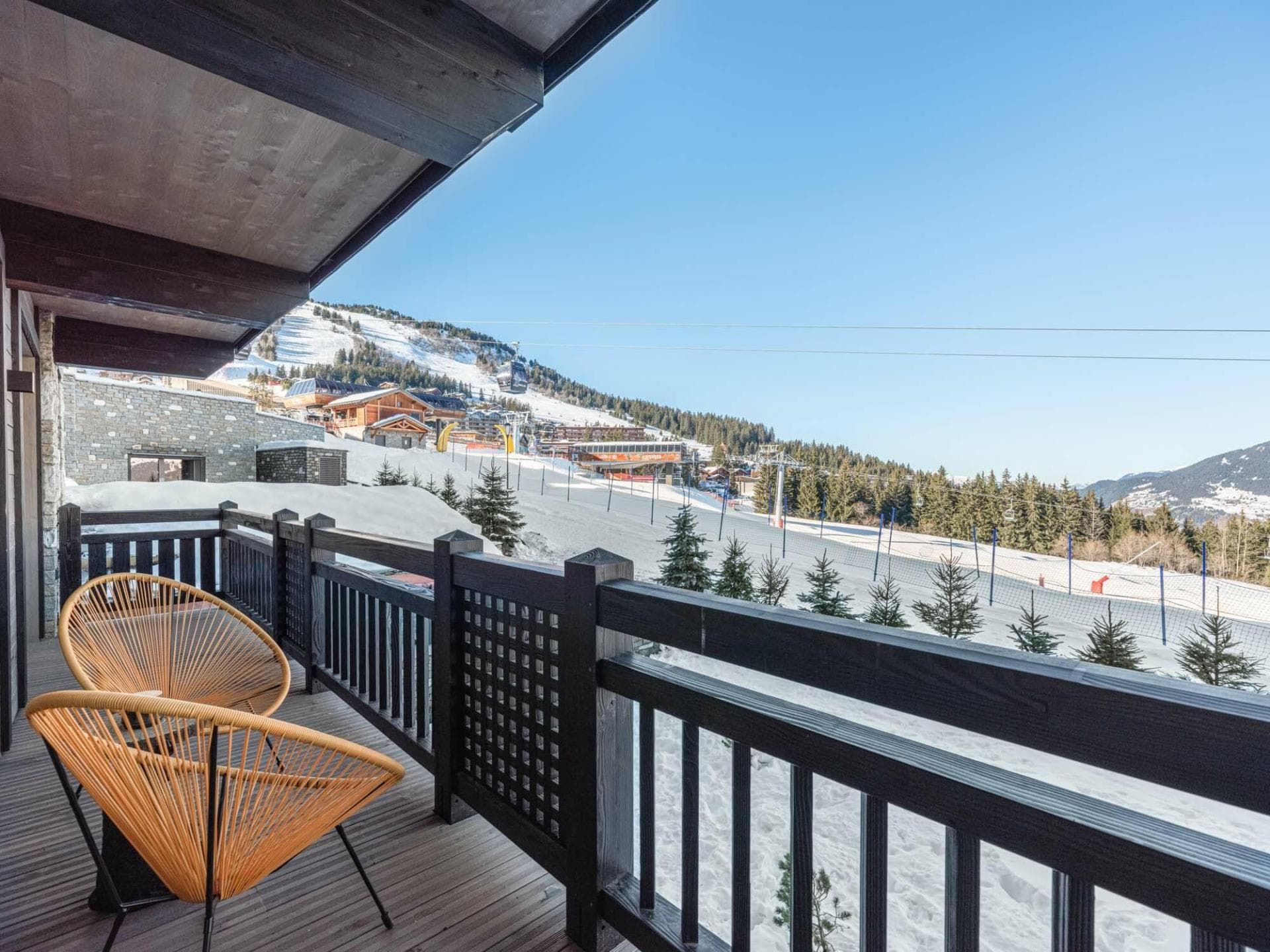 Private balcony with Acapulco chairs and direct ski-in/ski-out views
