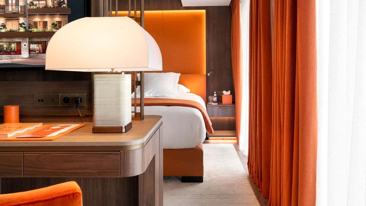 Bedroom with dedicated workspace and floor-to-ceiling orange curtains