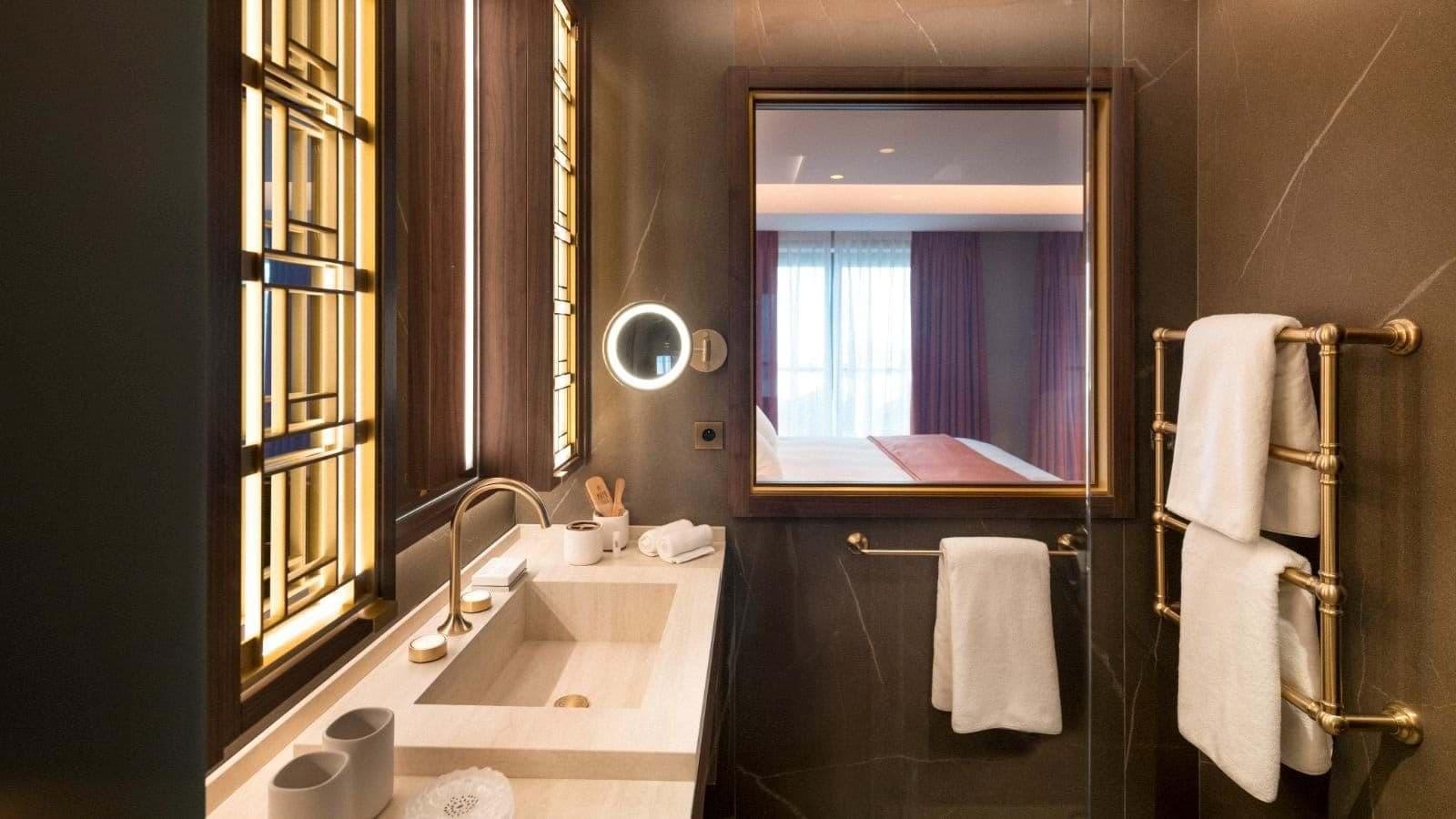 Bathroom with integrated stone vanity and heated towel rail