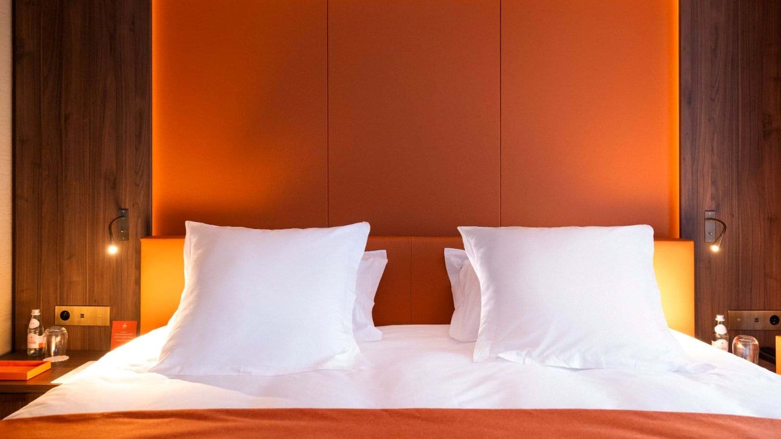 Padded headboard with integrated reading lights and bedside power ports