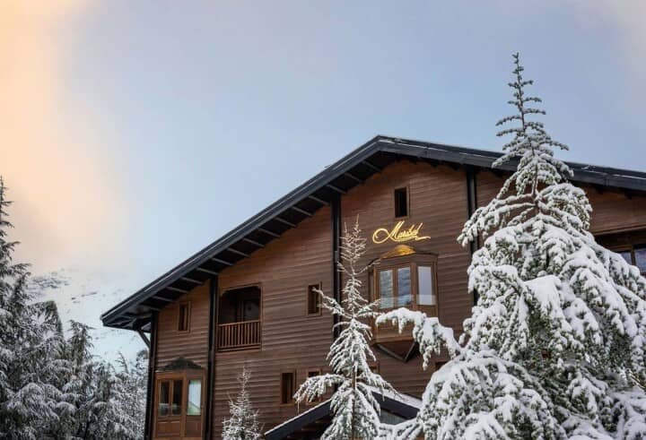 Timber chalet exterior with private balconies and bay windows