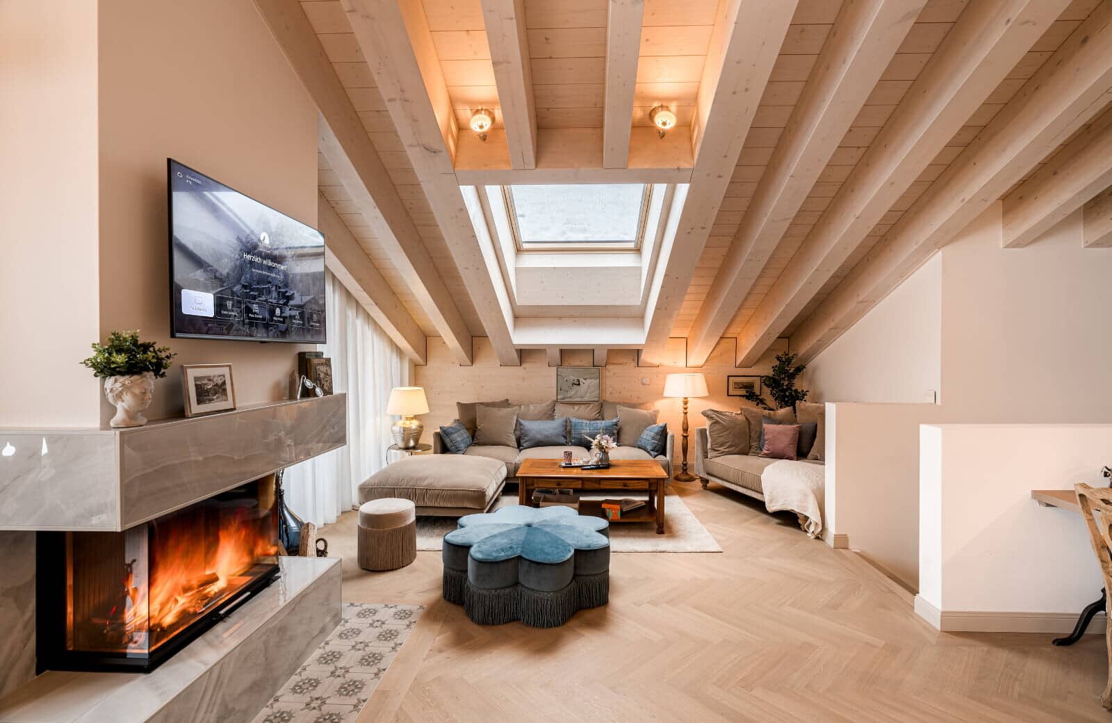 Living area with wood-beamed ceilings, skylight, and wood-burning fireplace