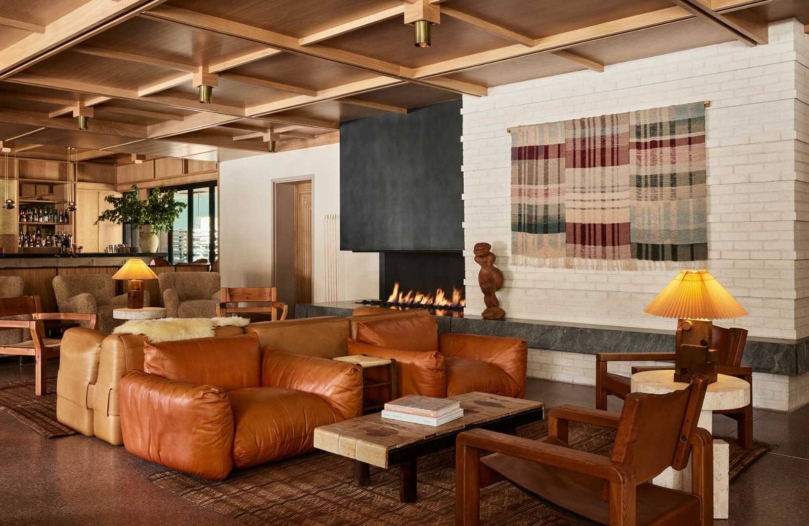 Living area with wood-coffered ceiling and wood-burning fireplace