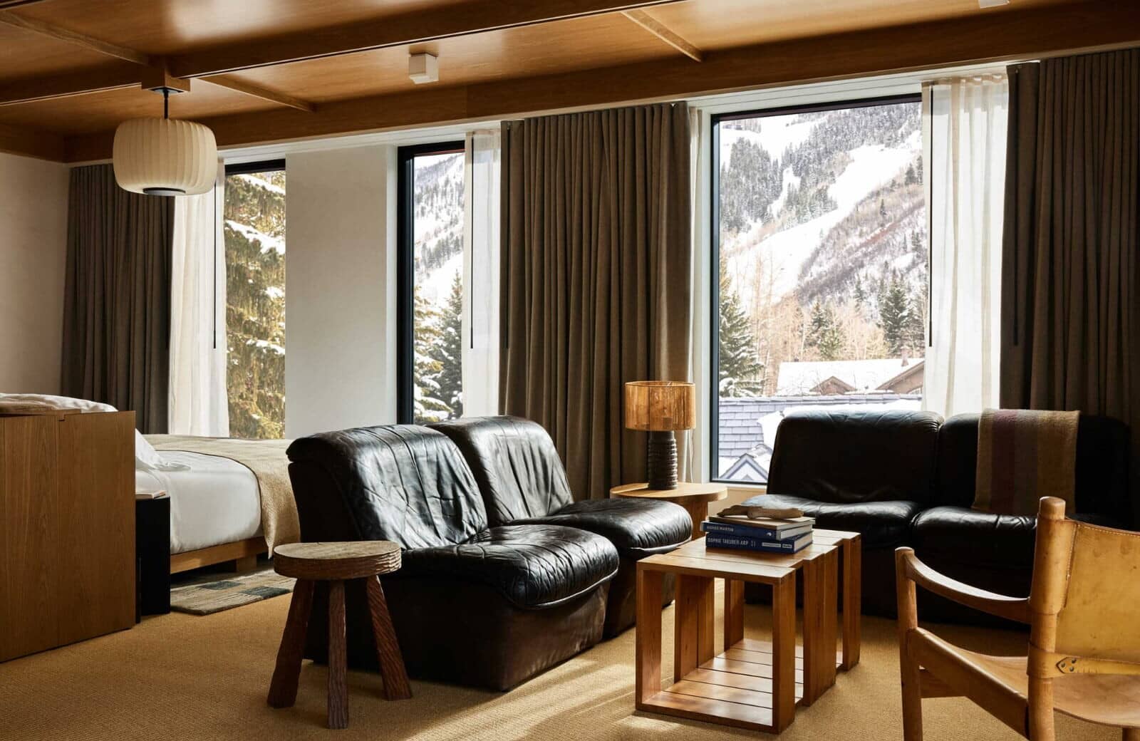 Studio living area with leather seating and ski slope views