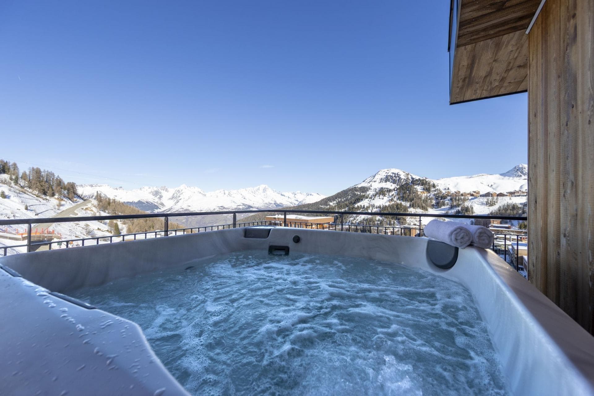 Private balcony hot tub with panoramic Alpine views