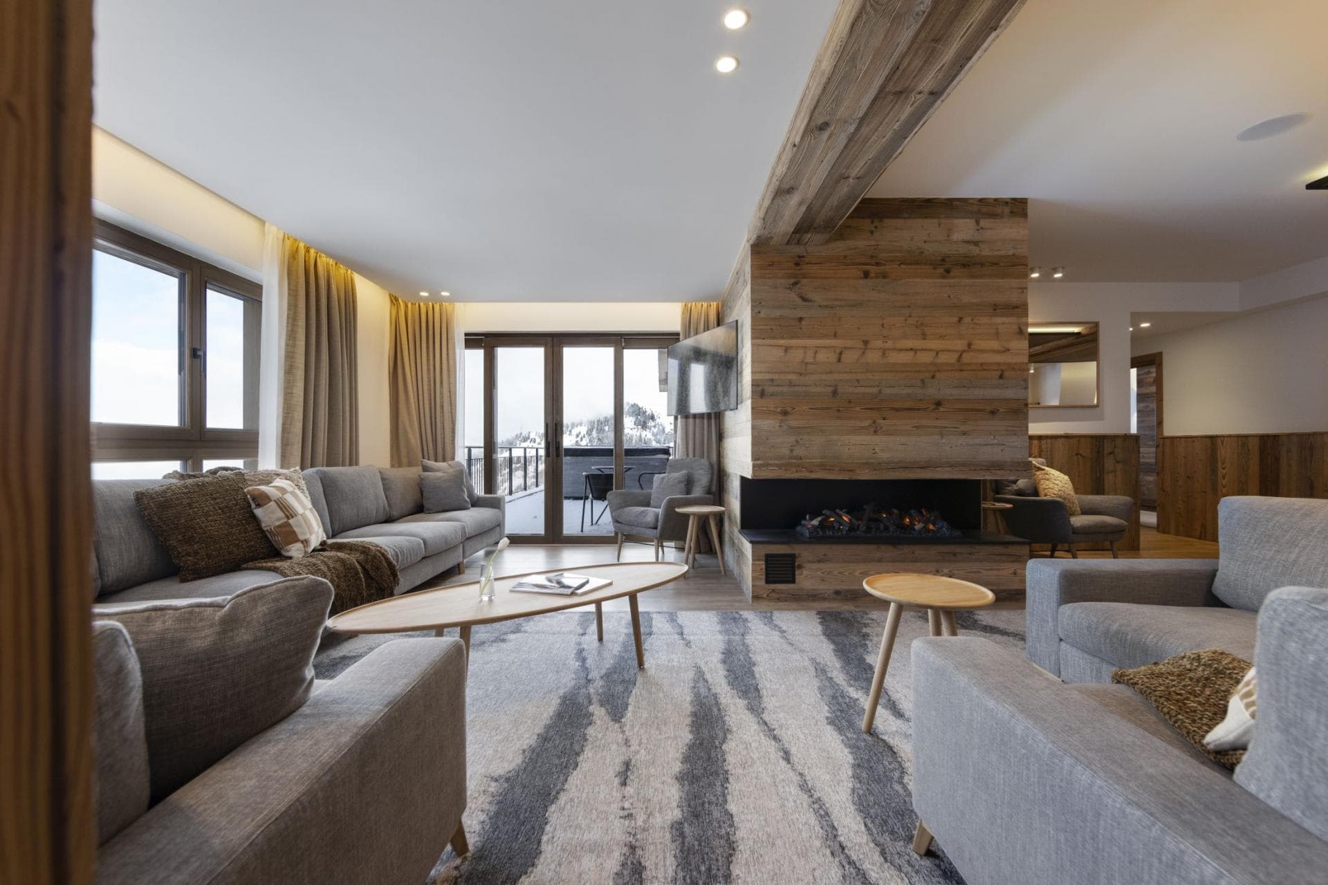 Living area with electric fireplace and balcony access