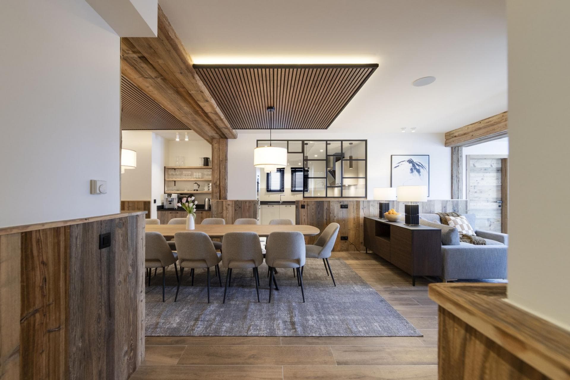 Open-plan dining area seating 10 with integrated coffee bar and lounge