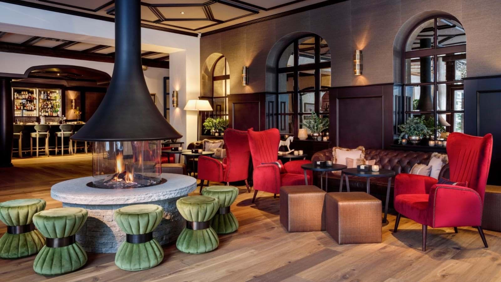 Lounge with circular 360-degree fireplace and adjacent cocktail bar