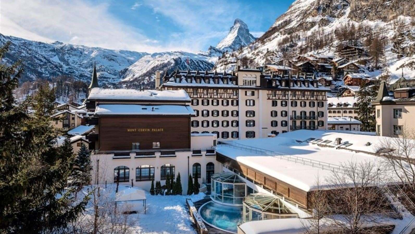 Hotel exterior with heated outdoor pool and Matterhorn mountain views