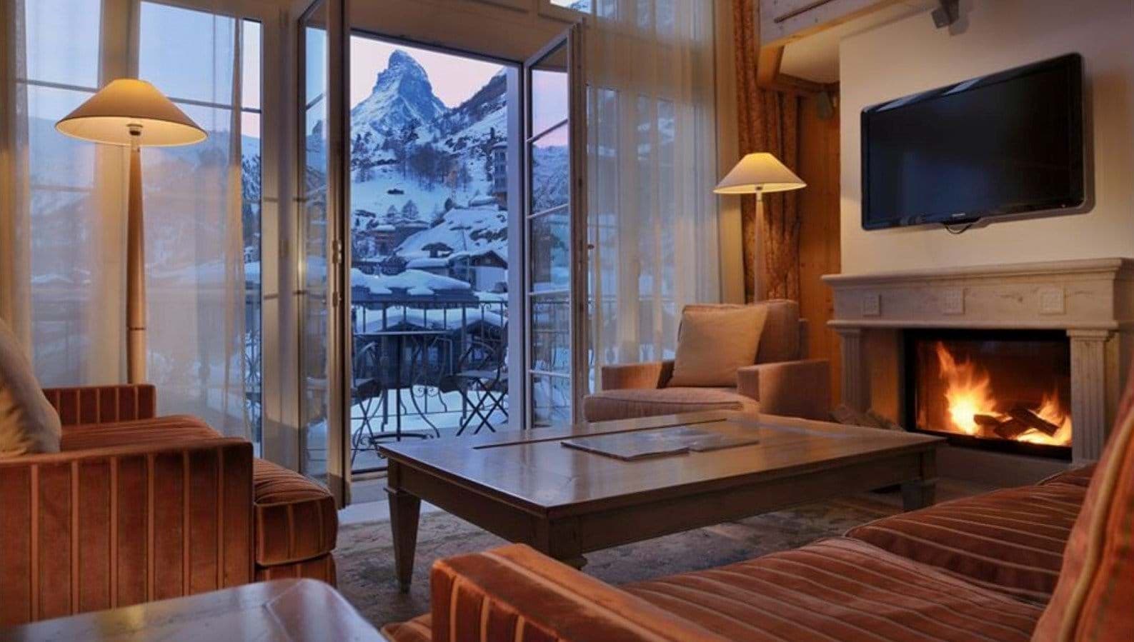 Living area with wood-burning fireplace and Matterhorn views from the balcony