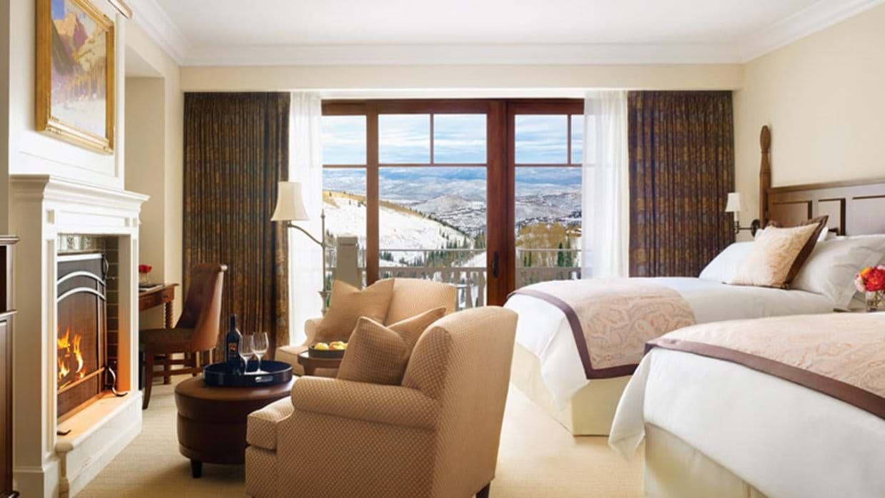 Bedroom with two queen beds, gas fireplace, and mountain views