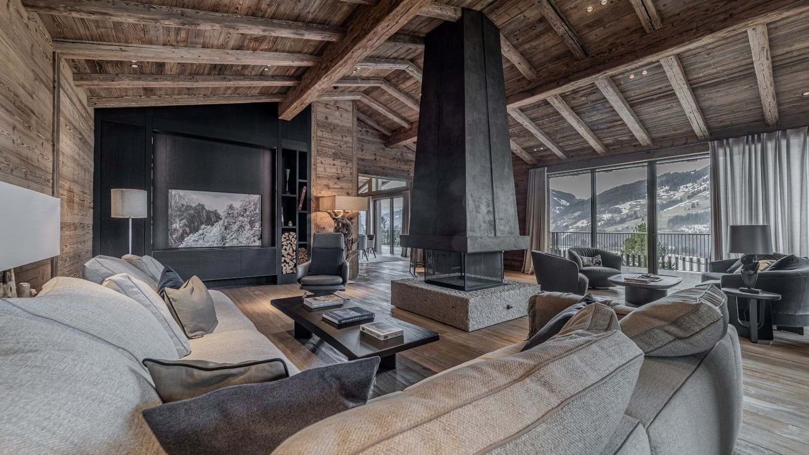 Living area with central 360-degree fireplace and alpine valley views