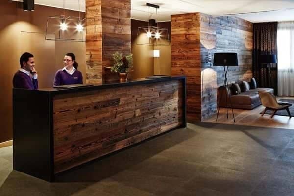 24-hour reception desk and lobby lounge with reclaimed wood accents