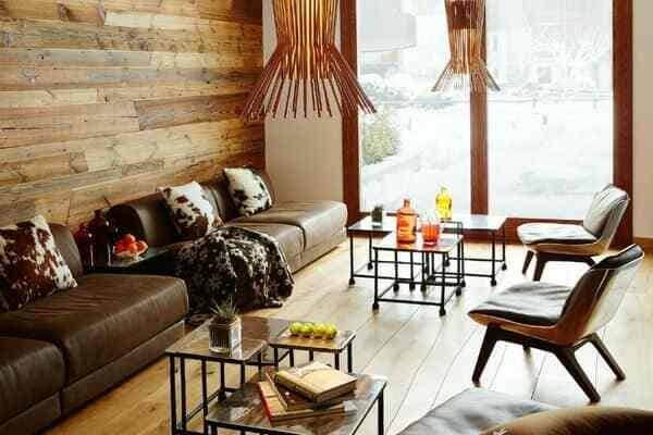 Living area with reclaimed wood wall and floor-to-ceiling windows