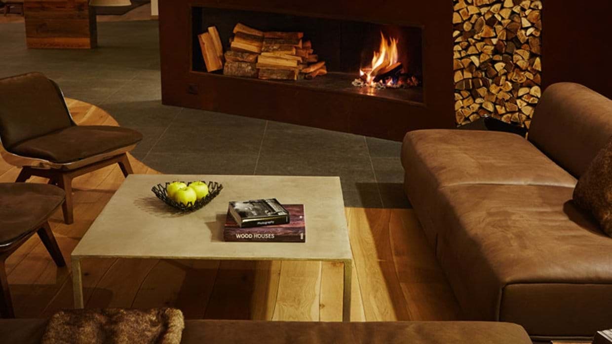 Living area with wood-burning fireplace and leather sofa seating