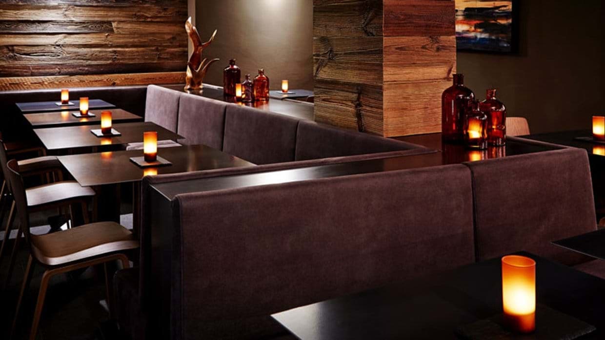 Dining area with booth seating and reclaimed wood accents