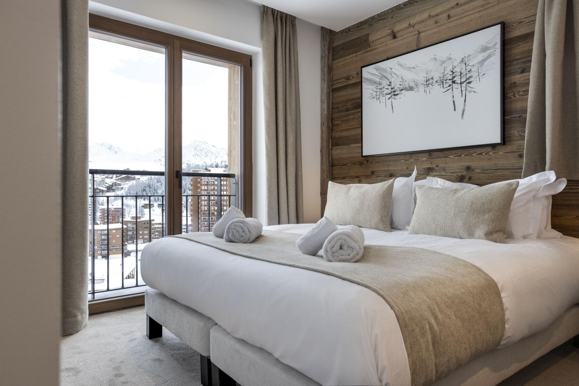 Guest bedroom with zip-and-link beds and alpine resort views